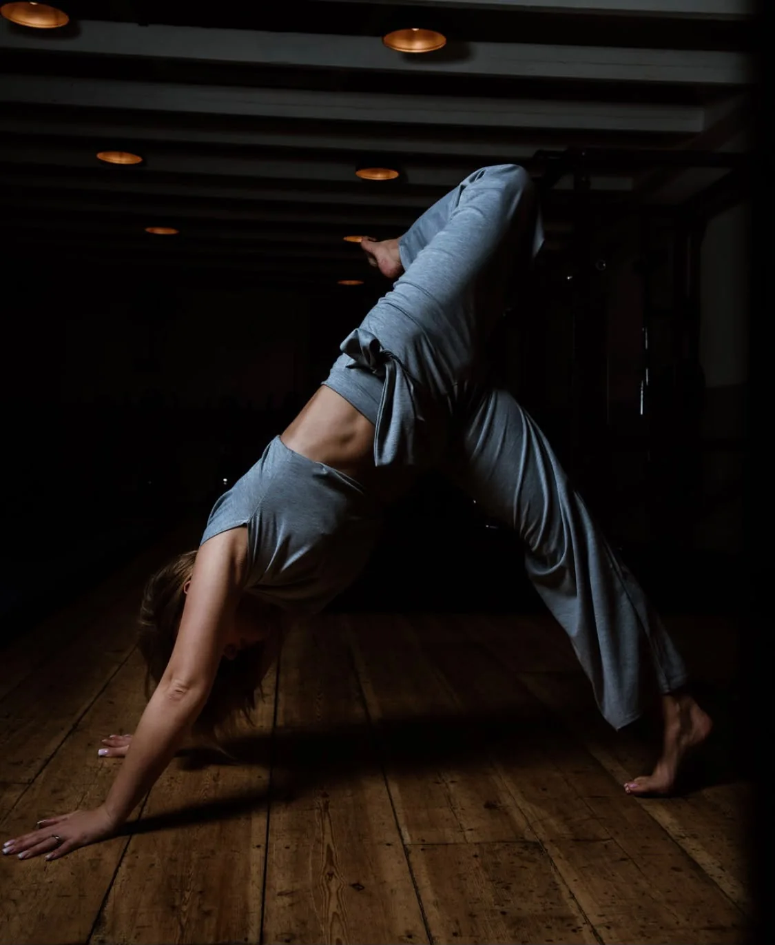 Yoga practice with one arm reaching overhead in a side stretch
