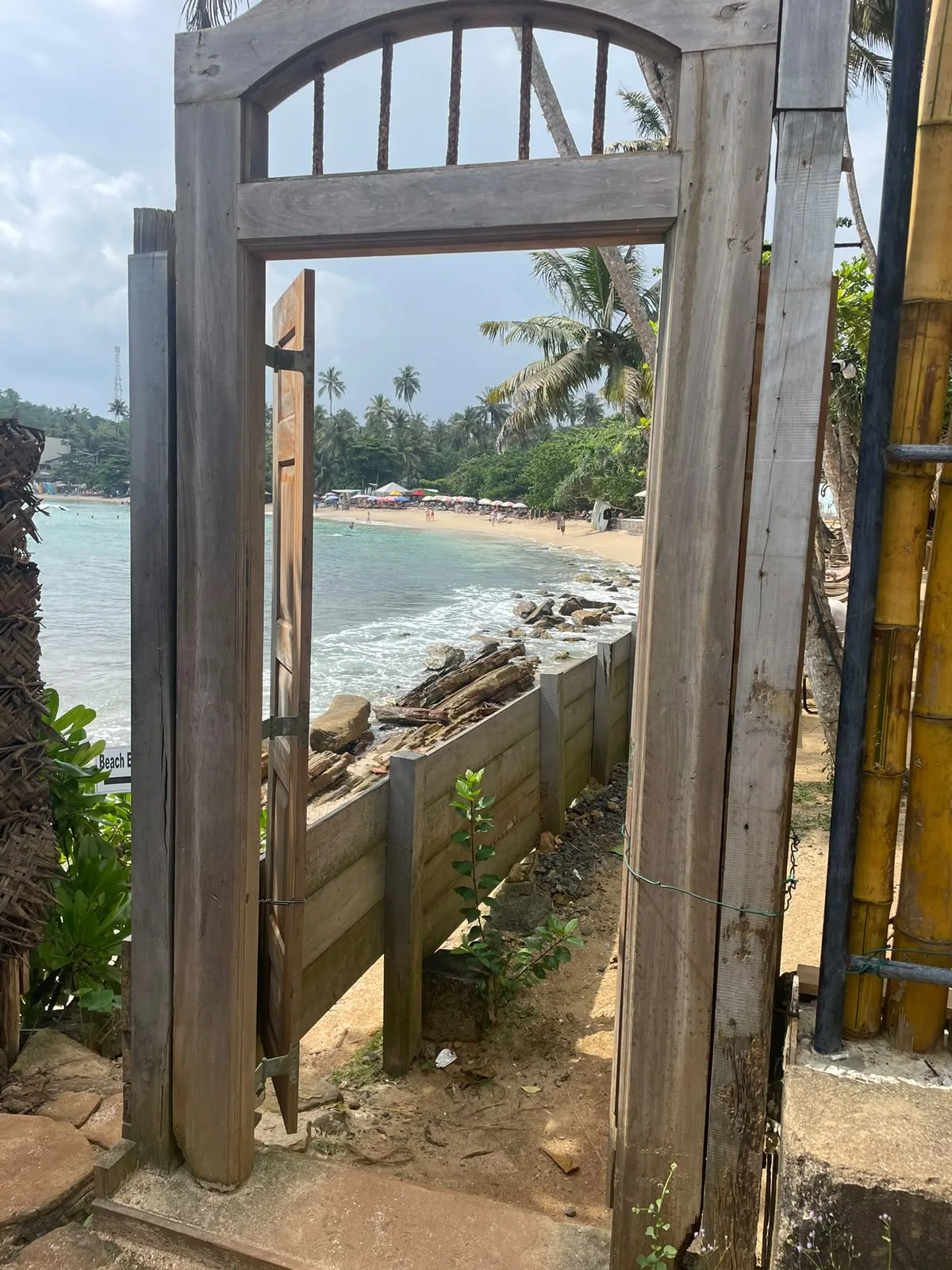 A coastal view framed by an open wooden doorway